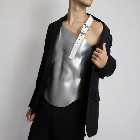 Person wearing a black jacket over a silver corset with a white belt, on a plain background. @powerfem.shop